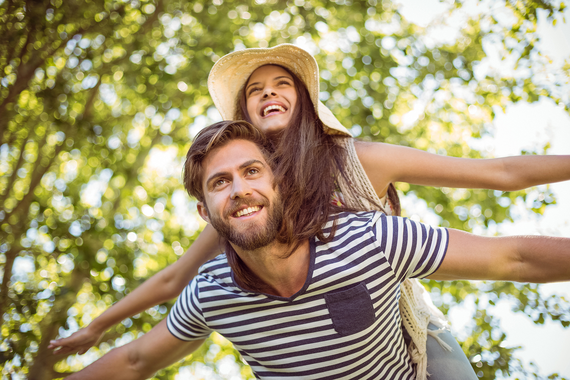 A dentist attentively examines a patient holding their cheek in a modern dental clinic.